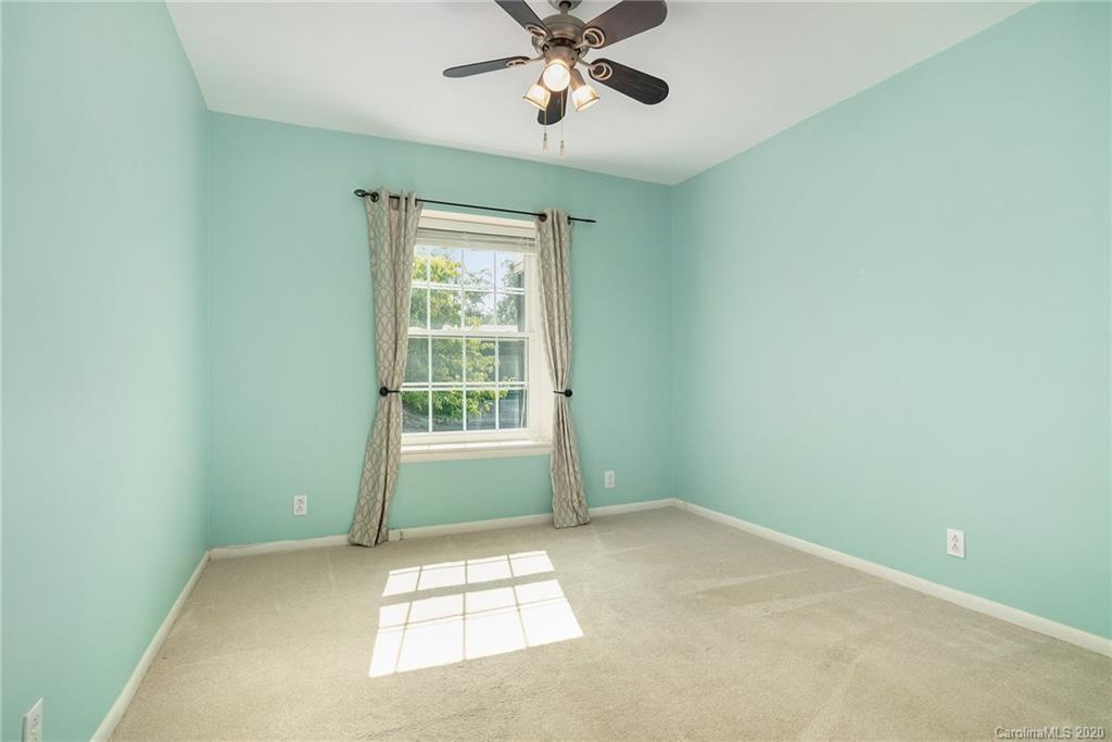 2628 Park Road, Unit H Charlotte, NC 28209 - Photo 19 of 39 an empty room with a window and a fan