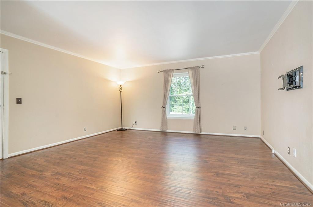 2628 Park Road, Unit H Charlotte, NC 28209 - Photo 3 of 39 an empty room with wooden floor and windows