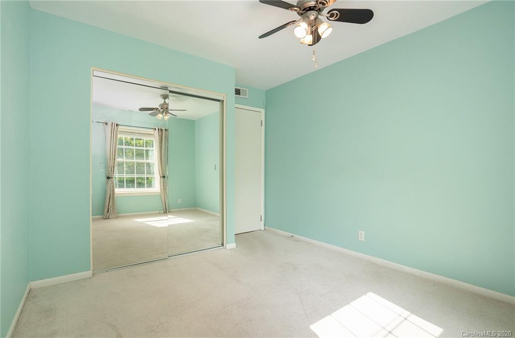 2628 Park Road, Unit H Charlotte, NC 28209 - Photo 21 of 39 a view of a big room with windows and chandelier fan