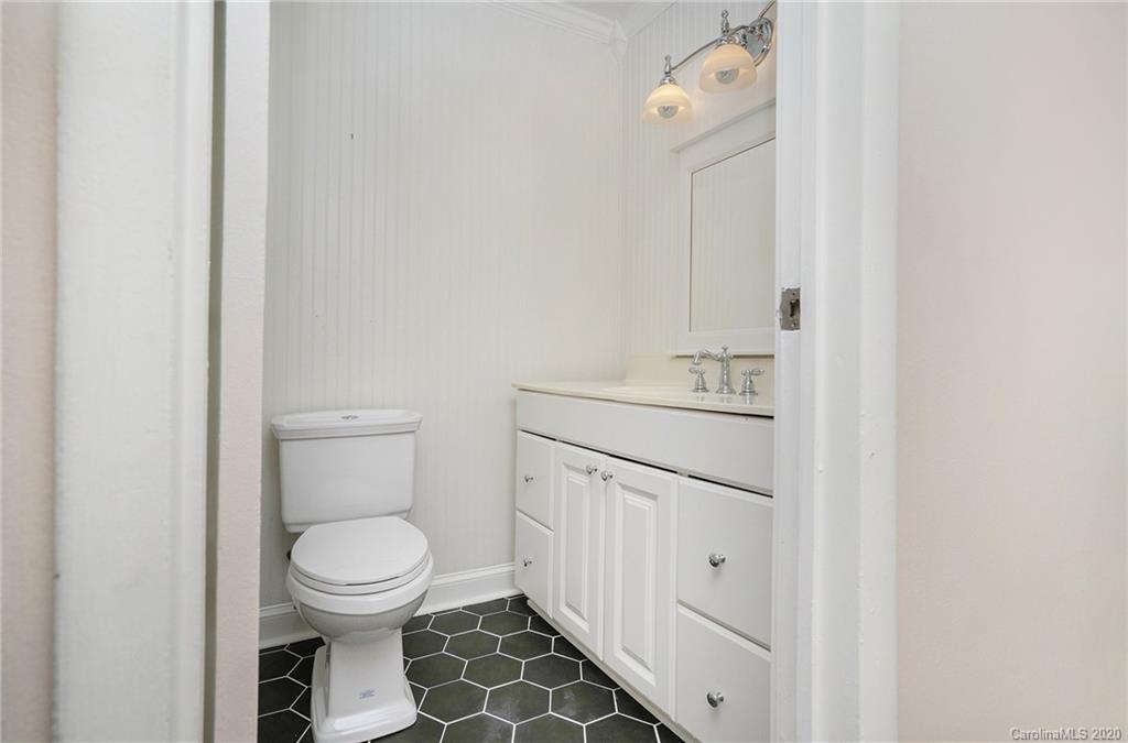 2628 Park Road, Unit H Charlotte, NC 28209 - Photo 23 of 39 a bathroom with a toilet sink and mirror