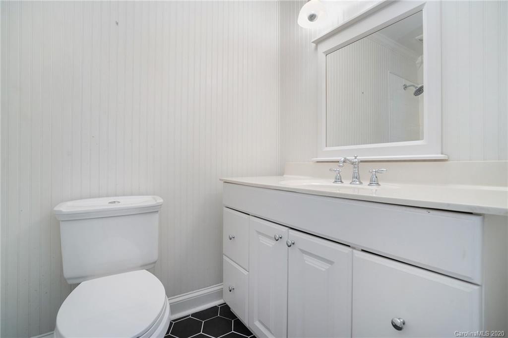 2628 Park Road, Unit H Charlotte, NC 28209 - Photo 24 of 39 a bathroom with a sink mirror vanity and toilet