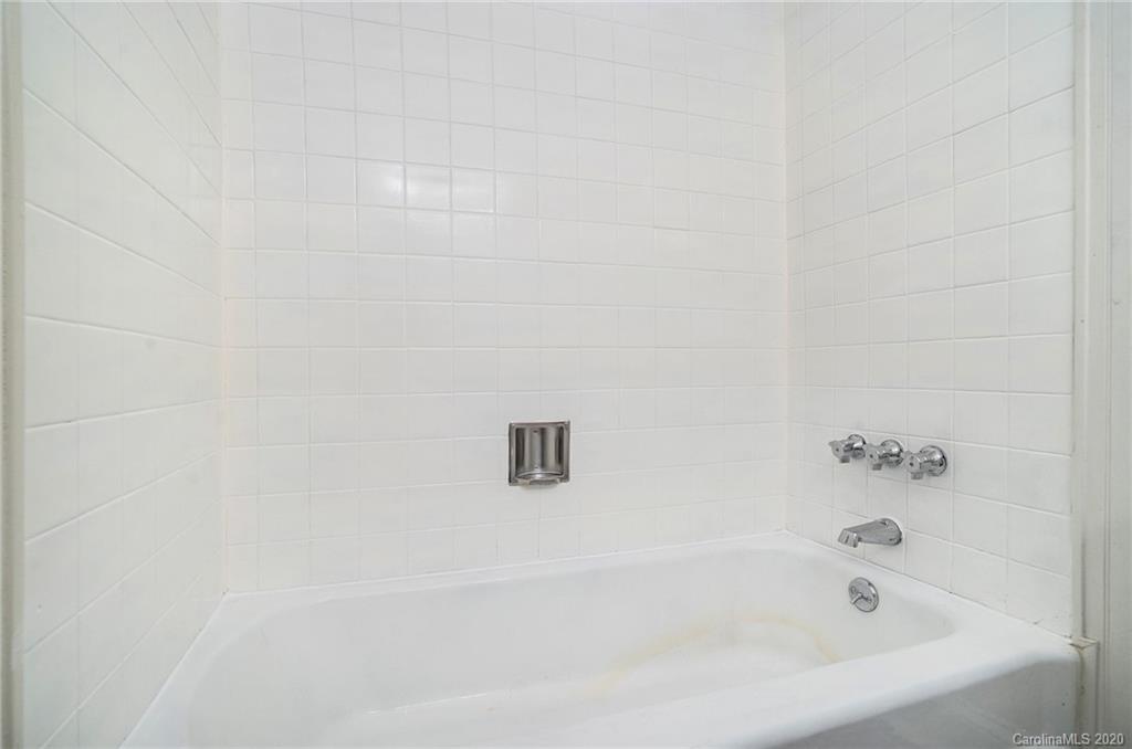 2628 Park Road, Unit H Charlotte, NC 28209 - Photo 25 of 39 a white bath tub sitting next to a white wooden wall