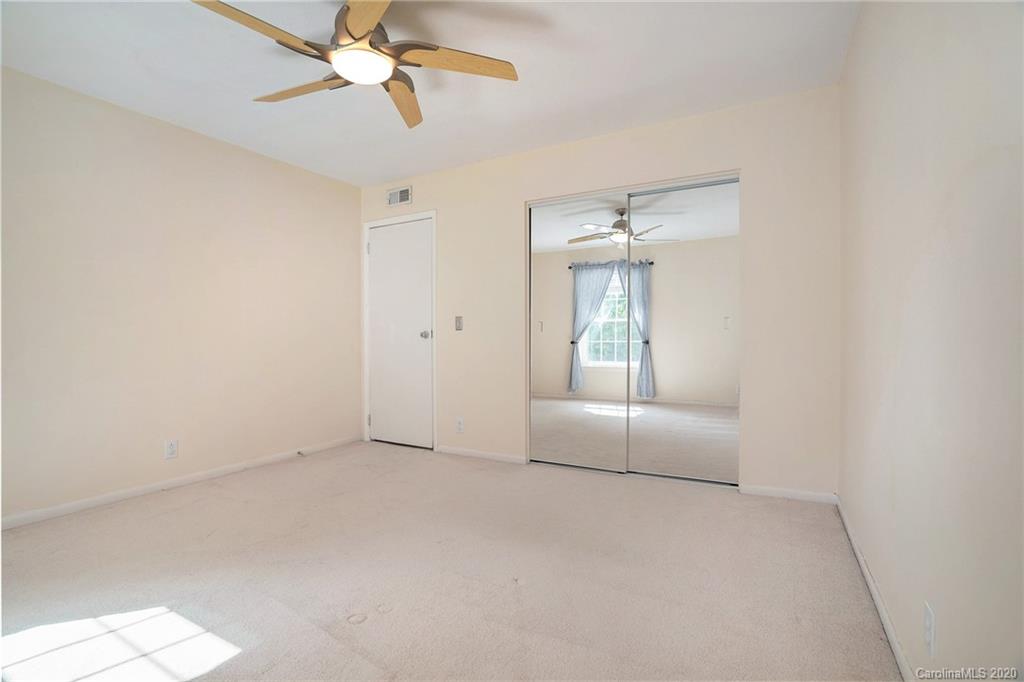 2628 Park Road, Unit H Charlotte, NC 28209 - Photo 28 of 39 an empty room with windows and fan