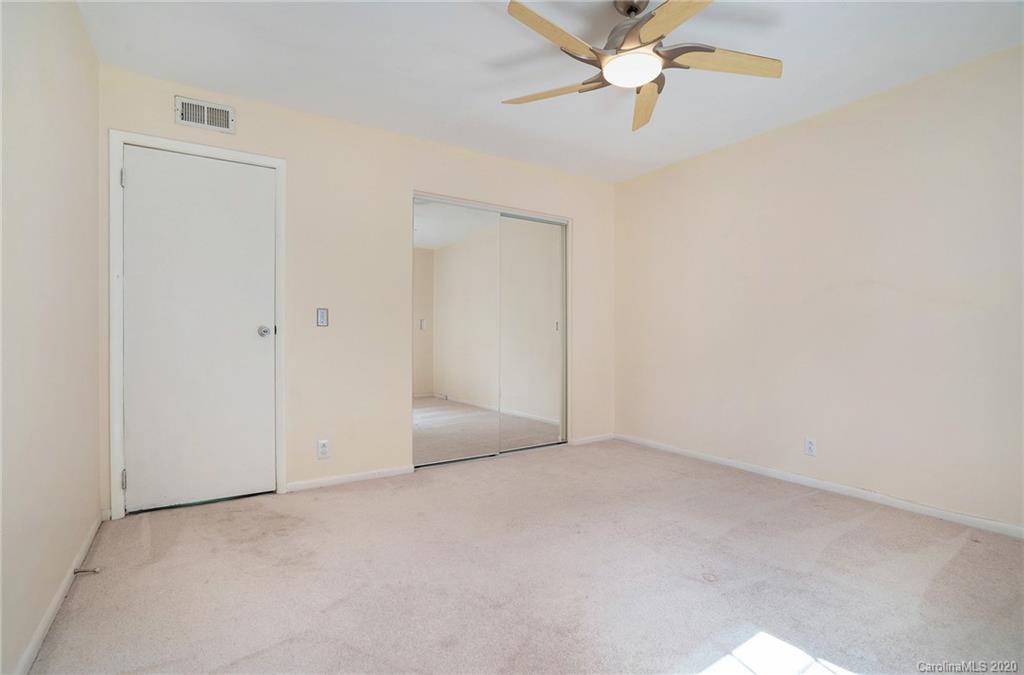 2628 Park Road, Unit H Charlotte, NC 28209 - Photo 29 of 39 an empty room with chandelier fan