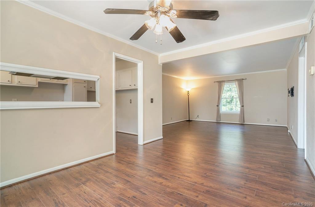2628 Park Road, Unit H Charlotte, NC 28209 - Photo 4 of 39 a view of an empty room with window and wooden floor