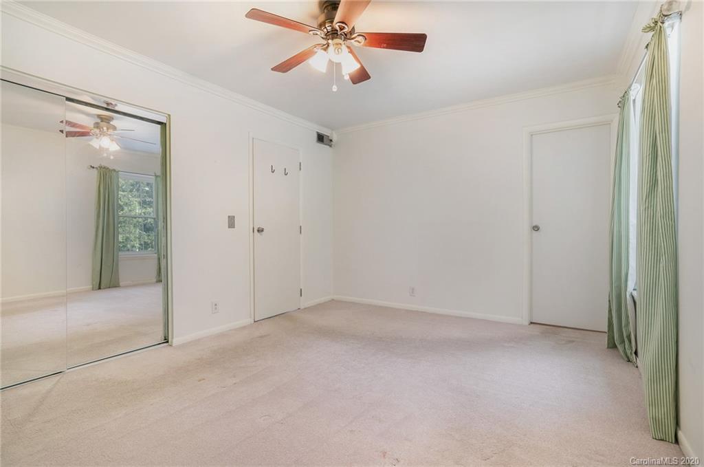 2628 Park Road, Unit H Charlotte, NC 28209 - Photo 31 of 39 an empty room with chandelier fan
