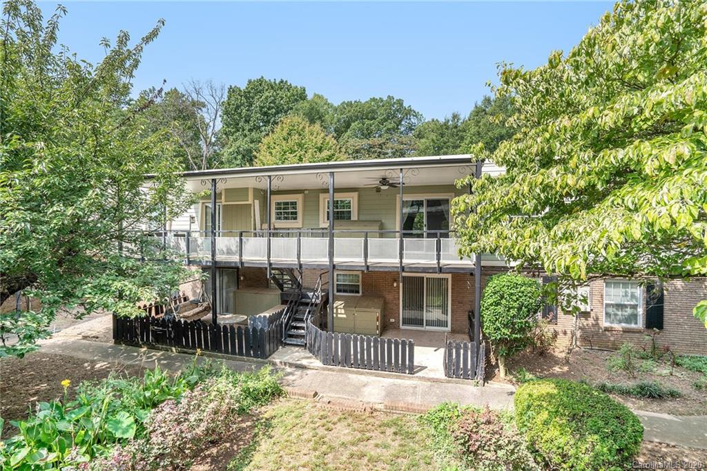 2628 Park Road, Unit H Charlotte, NC 28209 - Photo 35 of 39 a view of a house with a small yard and wooden fence