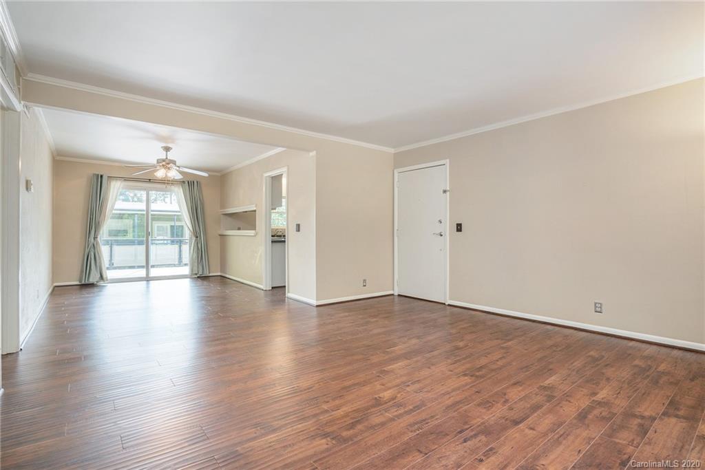2628 Park Road, Unit H Charlotte, NC 28209 - Photo 6 of 39 an empty room with wooden floor and windows