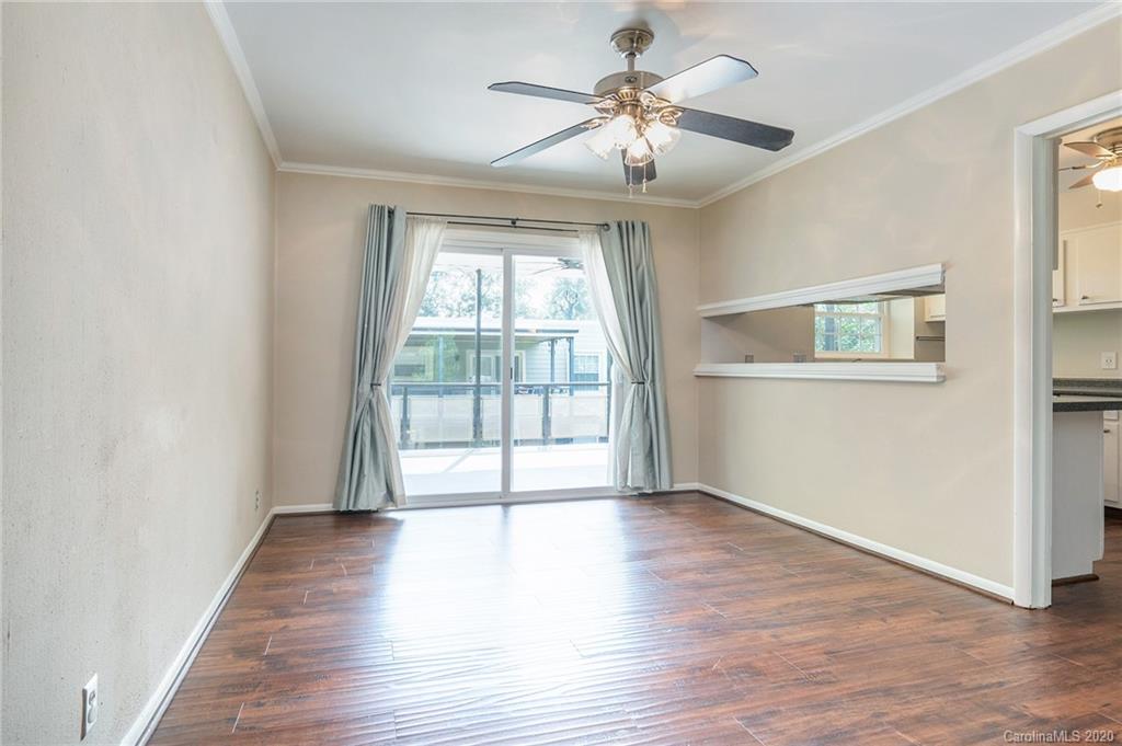 2628 Park Road, Unit H Charlotte, NC 28209 - Photo 7 of 39 an empty room with wooden floor fan and windows