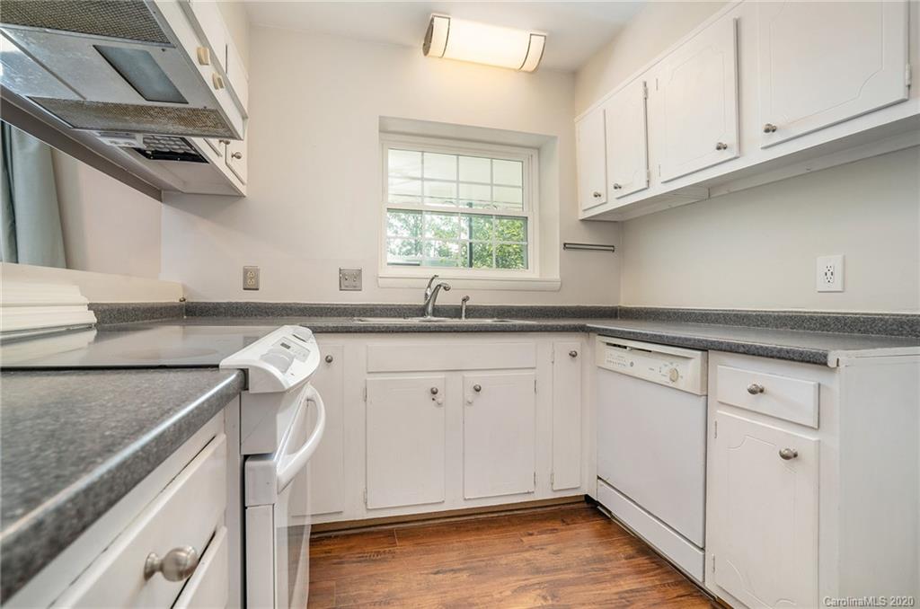 2628 Park Road, Unit H Charlotte, NC 28209 - Photo 9 of 39 a kitchen with granite countertop cabinets a sink a window and stainless steel appliances