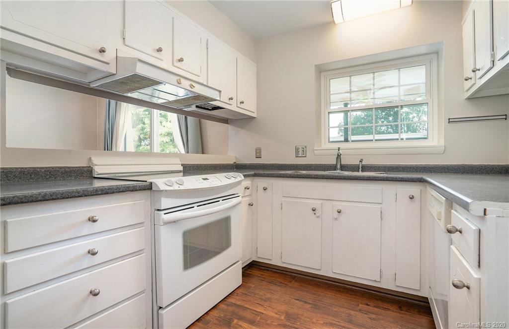 2628 Park Road, Unit H Charlotte, NC 28209 - Photo 10 of 39 a kitchen with granite countertop white cabinets stainless steel appliances and a window