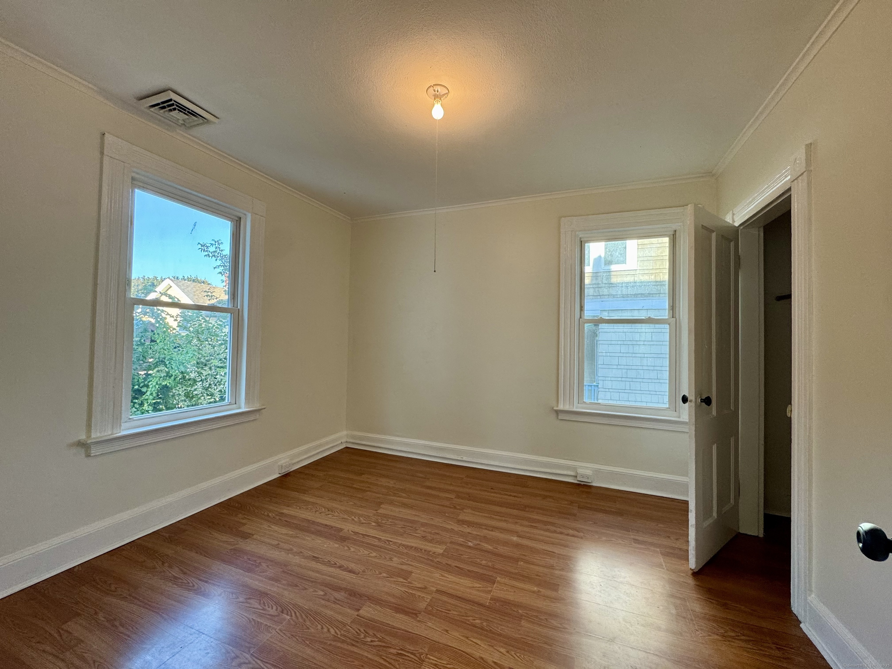 14 Culvert Street, Unit 2 Torrington, CT 06790 - Photo 17 of 17 a view of an empty room with wooden floor and a window
