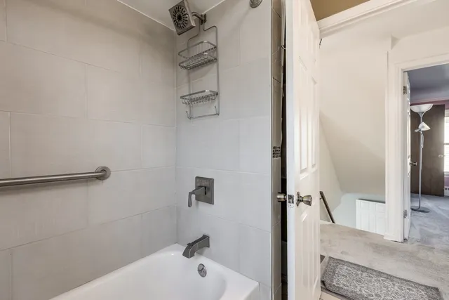 a bathroom with a tub and a shower