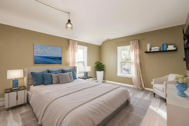 a bedroom with a bed and a night stand