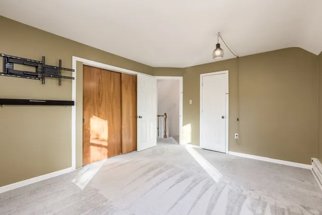 a view of a room with a refrigerator and window