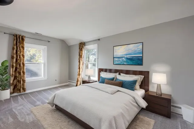 a bedroom with a large bed and a window