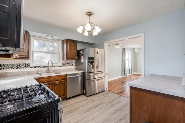 a kitchen with a stove a sink and a refrigerator