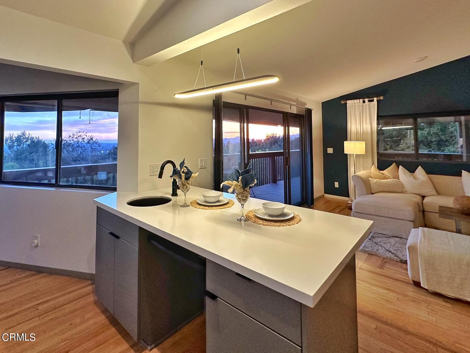 3680 Ranch Top Road Pasadena, CA 91107 - Photo 13 of 54 a kitchen with a sink and a large mirror next to a window