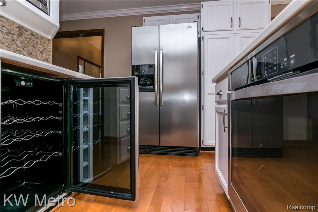2211 West Wardlow Road Highland, MI 48357 - Photo 11 of 53 Stove, Wine, & refrigerator