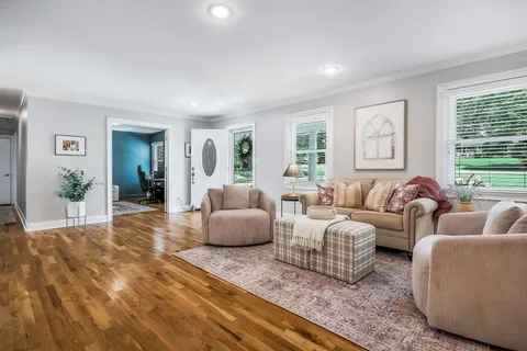 a kitchen with granite countertop a table chairs refrigerator and cabinets