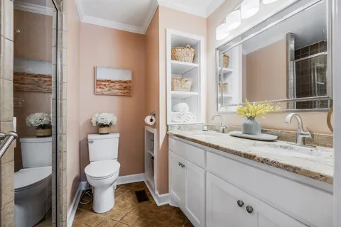 a bathroom with a sink toilet a mirror and shower