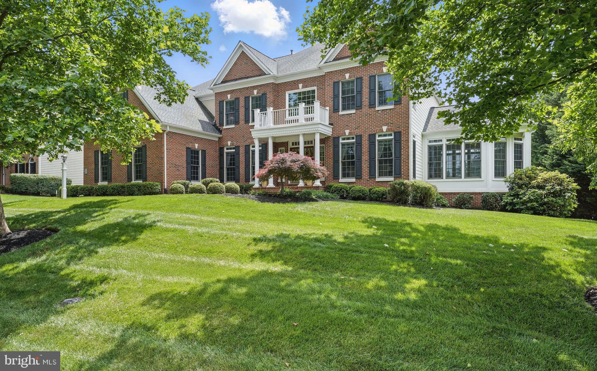 a front view of a house with garden and porch