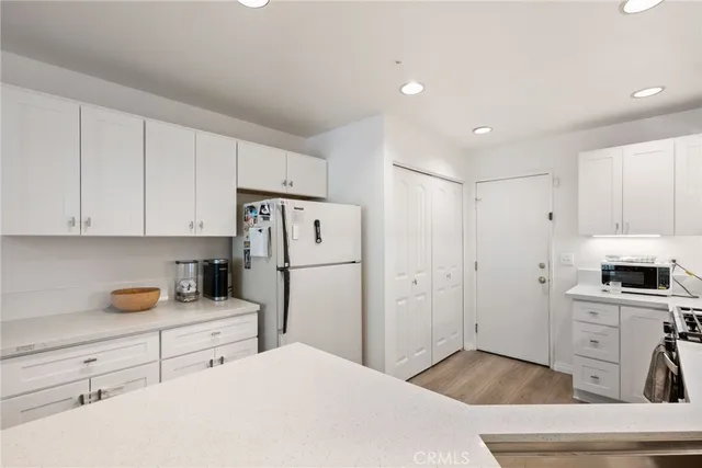 a kitchen with stainless steel appliances a refrigerator sink and cabinets