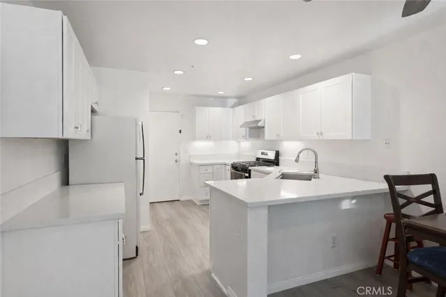 a kitchen with a sink appliances and cabinets