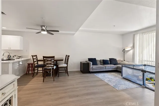 a living room with furniture wooden floor and a window