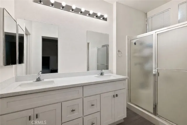 a bathroom with a double vanity sink and mirror