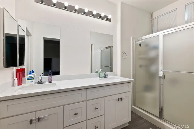 a bathroom with a double vanity sink and mirror
