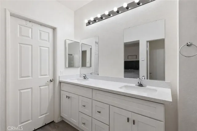 a bathroom with a double vanity sink and mirror