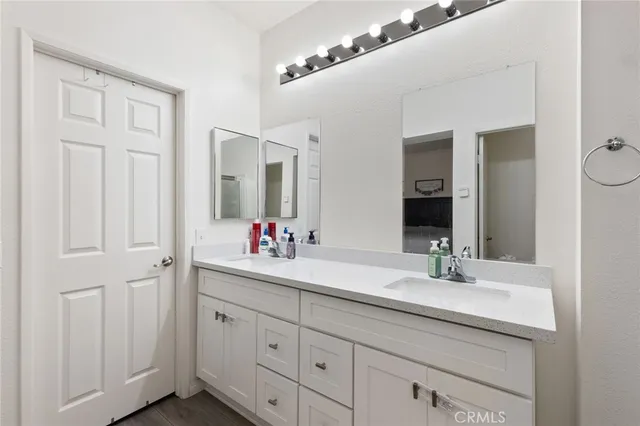 a bathroom with a double vanity sink and a mirror