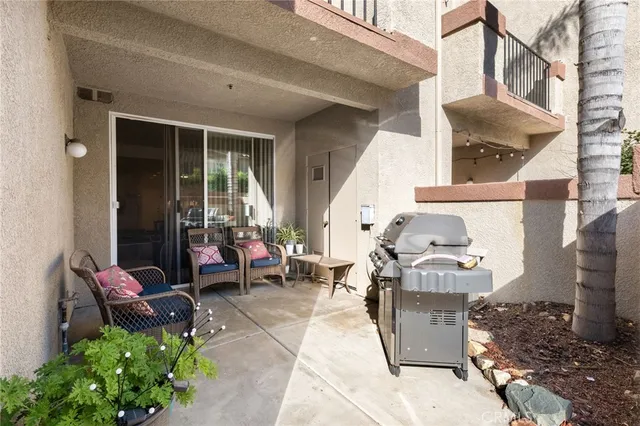 a view of a patio with table and chairs and potted plants