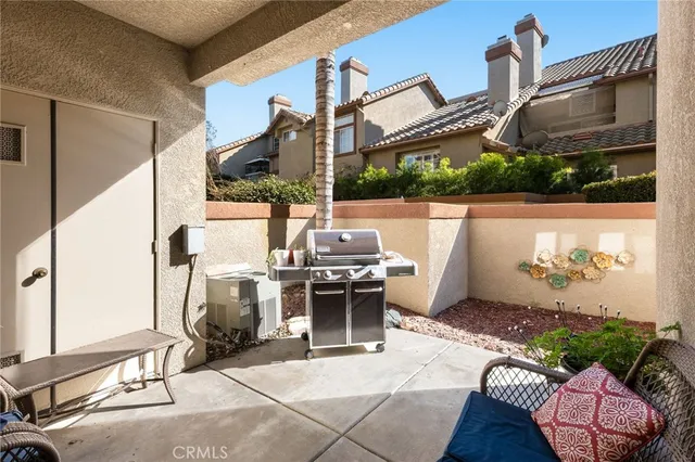 a view of a patio with a table and chairs
