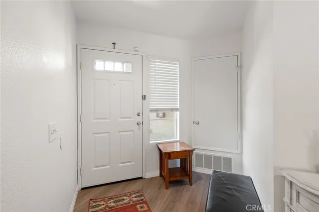 a view of a bedroom with furniture and wooden floor