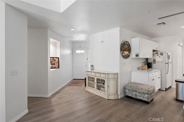 a room with a bed and a clock on the wall