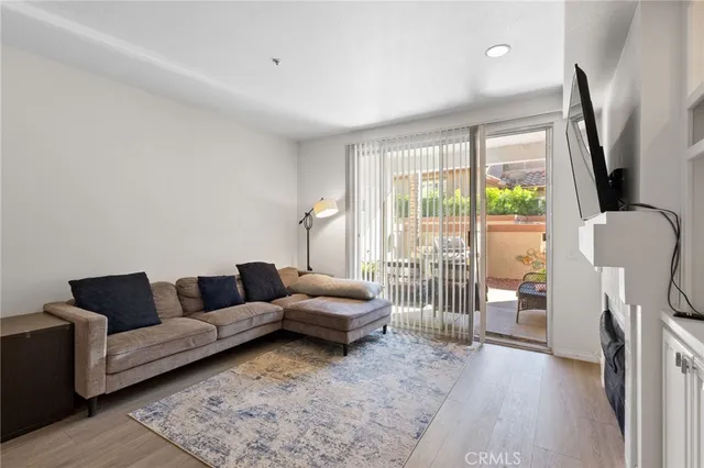 a living room with furniture and a floor to ceiling window