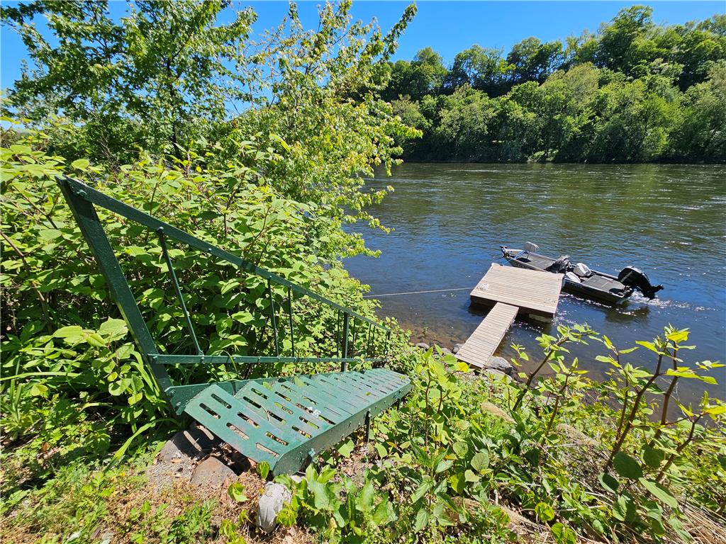 190 Canal Road Easton, PA 18042 - Photo 28 of 39 a wooden bench sitting in a lake next to a yard