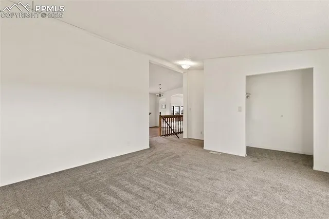 a bedroom with a bed wooden floor and lamp