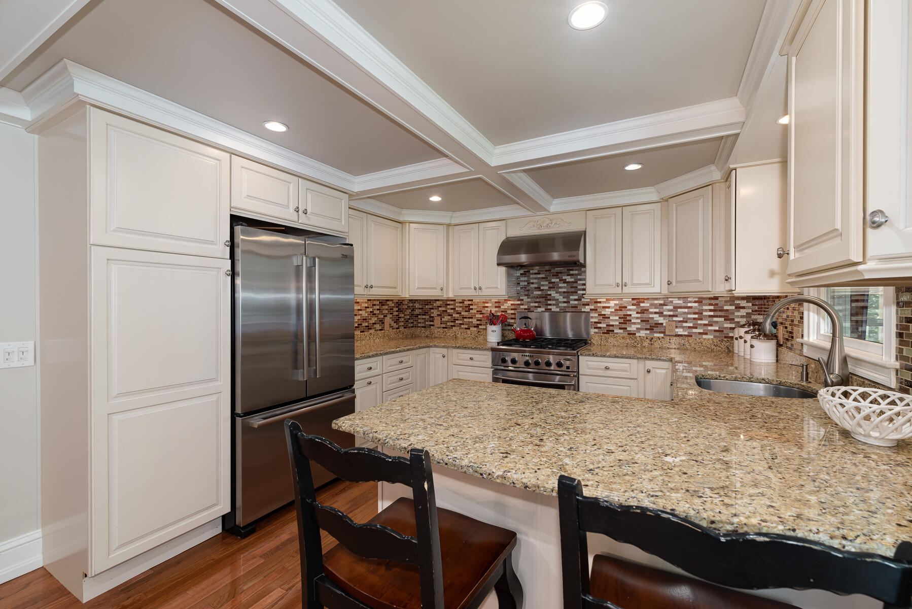 106 Scraggy Neck Road Cataumet, MA 02534 - Photo 12 of 43 a kitchen with refrigerator cabinets and wooden floor