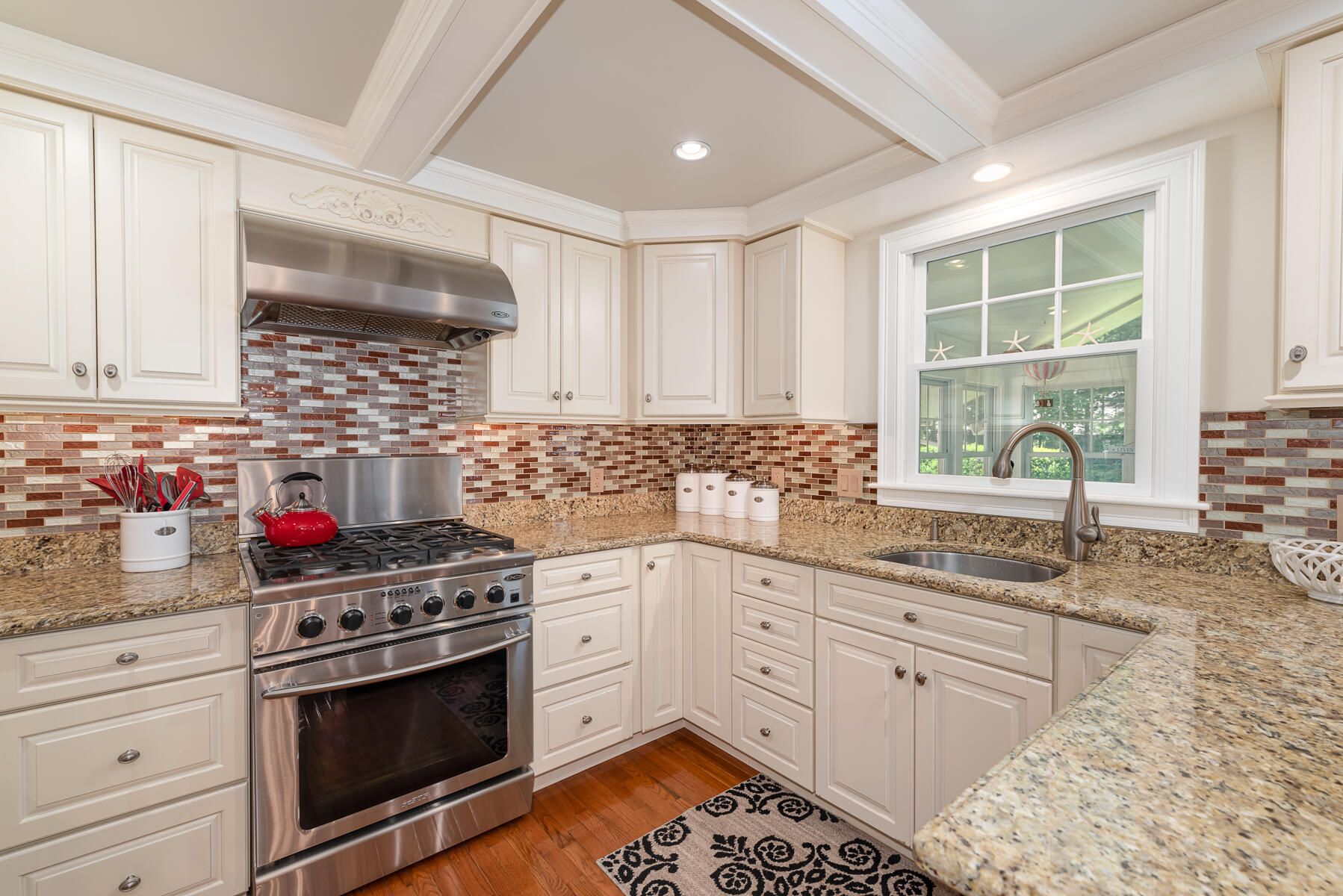 106 Scraggy Neck Road Cataumet, MA 02534 - Photo 13 of 43 a kitchen with stainless steel appliances white cabinets and a stove top oven