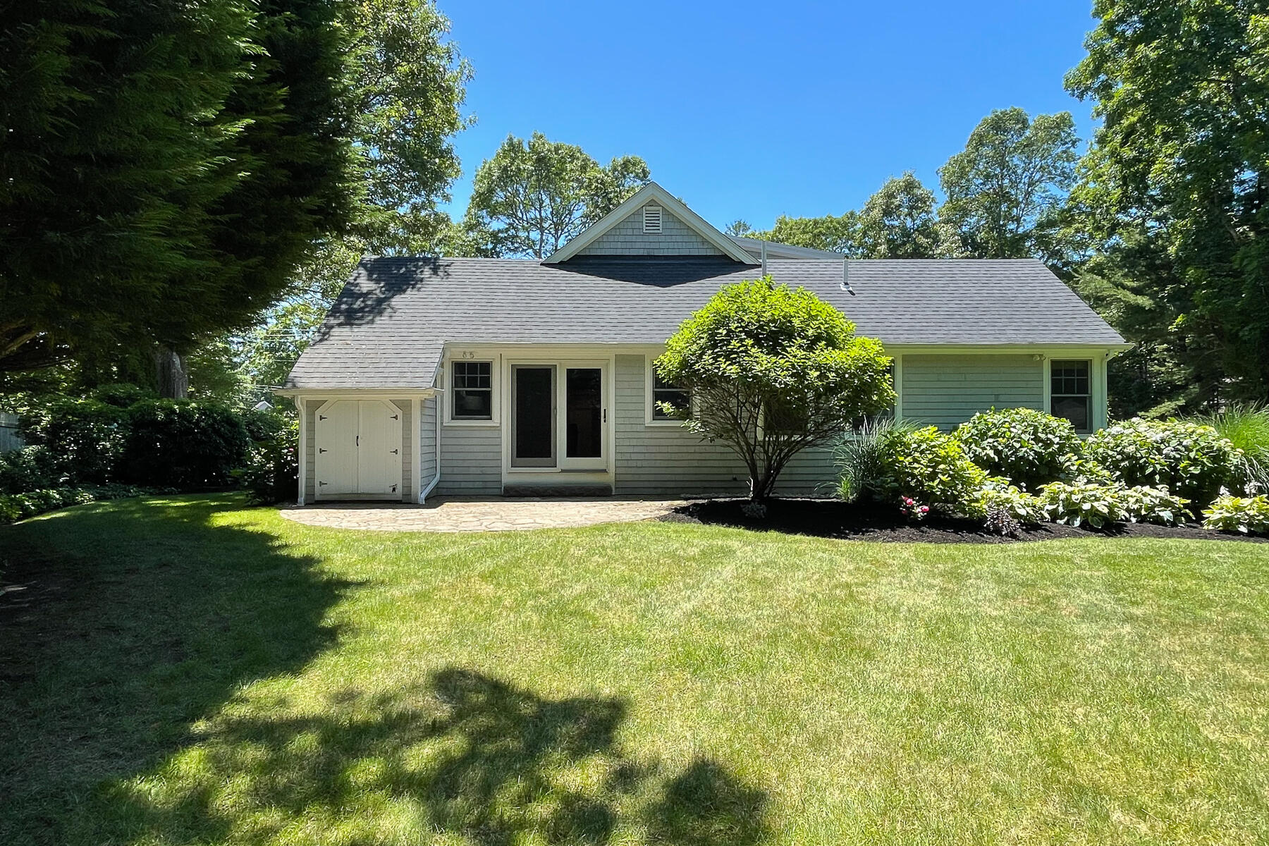 106 Scraggy Neck Road Cataumet, MA 02534 - Photo 32 of 43 a front view of a house with a yard and garage