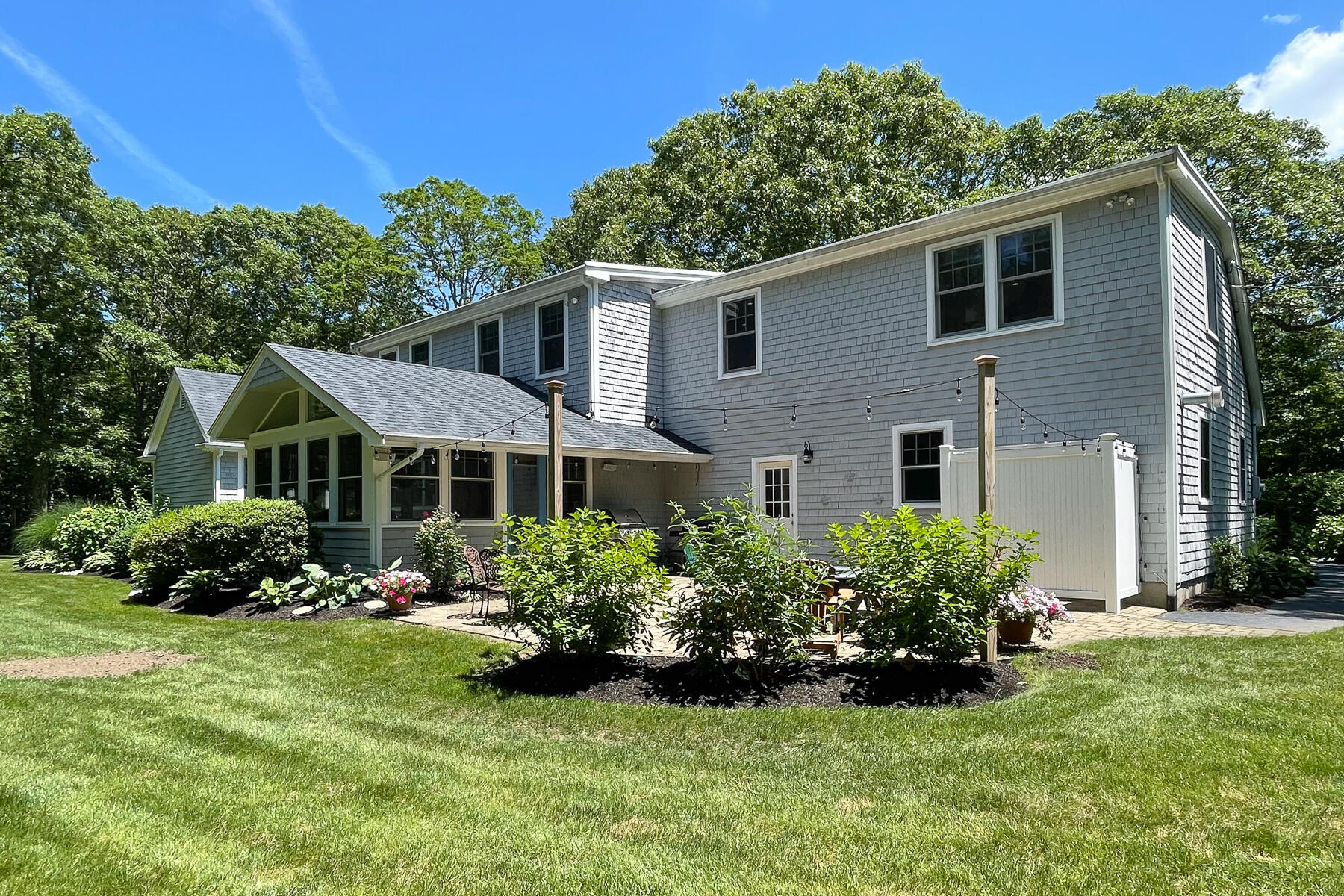 106 Scraggy Neck Road Cataumet, MA 02534 - Photo 33 of 43 a front view of a house with a yard and potted plants