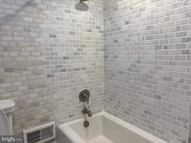 a bathroom with a sink and a brick building