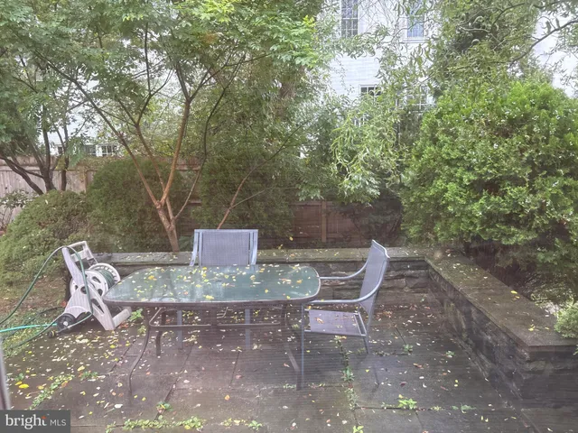 a view of a backyard with table and chairs