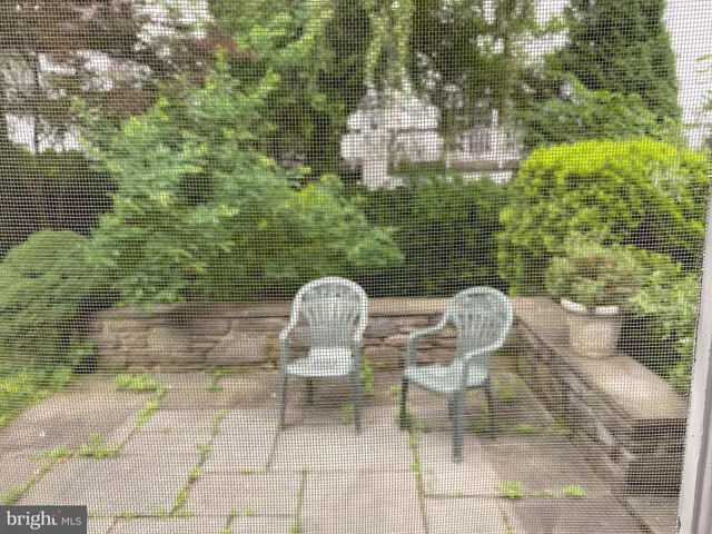a view of back yard of the house with outdoor seating