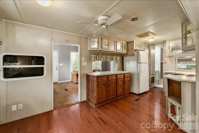 a kitchen with stainless steel appliances granite countertop a refrigerator a stove and a sink with cabinets