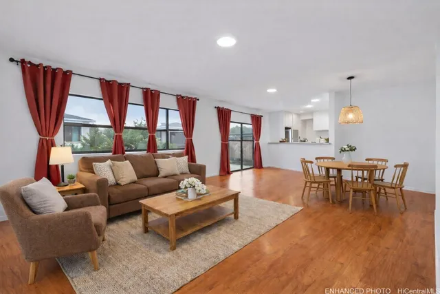 a living room with furniture a rug and a large window