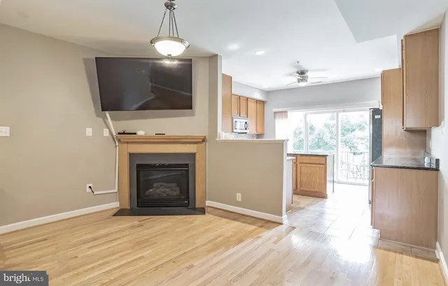 a view of a kitchen with a sink a refrigerator and a fireplace